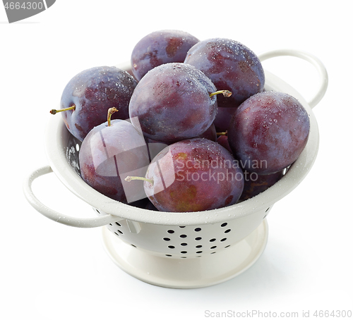 Image of fresh ripe plums in colander
