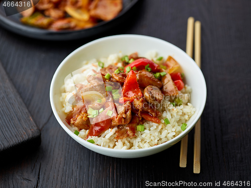 Image of fried rice and vegetables with hot chicken sauce