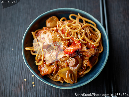 Image of fried noodles and vegetables with hot chicken sauce