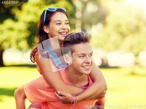 Image of happy teenage couple having fun at summer park