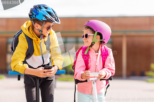 Image of school children with smartphones and scooters