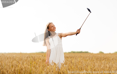 Image of happy young girl taking selfie by smartphone