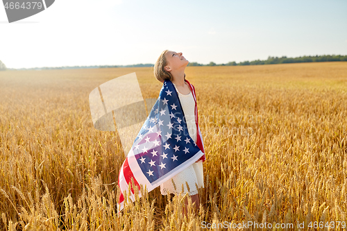 Image of happy girl in american flag on cereal field