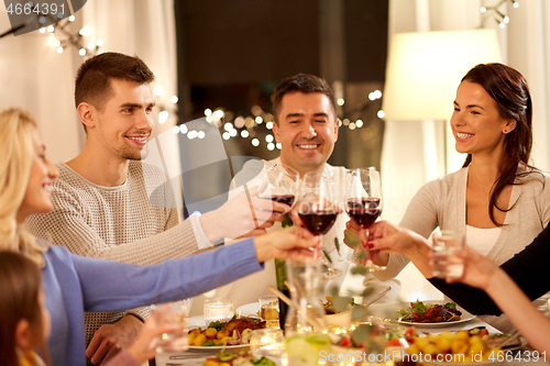 Image of happy family having dinner party at home