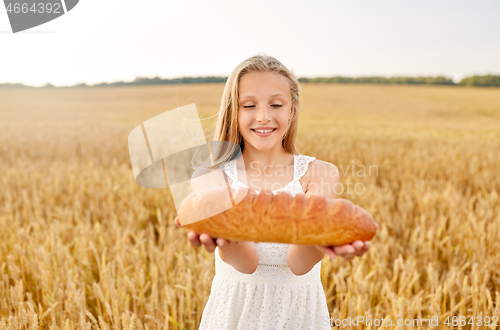 Image of girl with loaf of white bread on cereal field