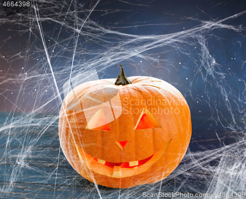 Image of pumpkin or jack o lantern and spiderweb