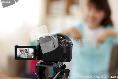 Image of female blogger making video blog about shopping