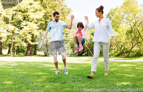 Image of happy family walking in summer park