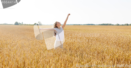 Image of happy smiling young girl on cereal field in summer