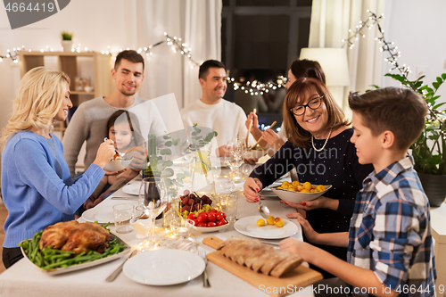 Image of happy family having dinner party at home