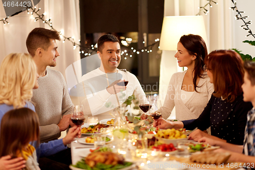 Image of happy family having dinner party at home