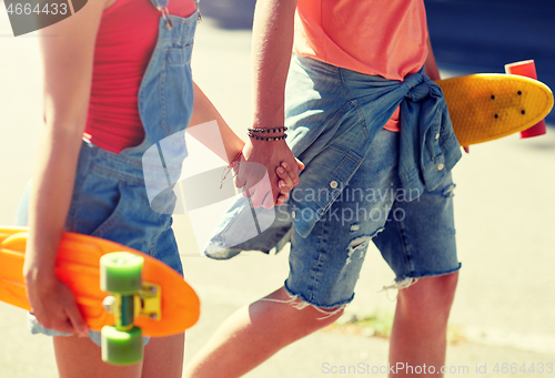 Image of close up of young couple with skateboards in city