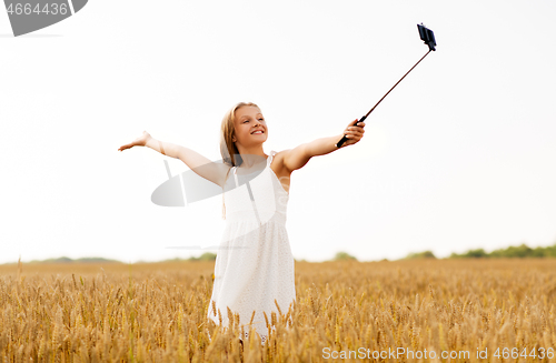 Image of happy young girl taking selfie by smartphone