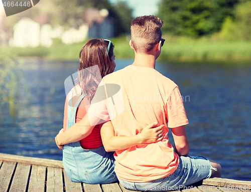 Image of happy teenage couple hugging on river summer berth