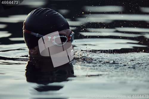 Image of triathlete swimmer having a break during hard training