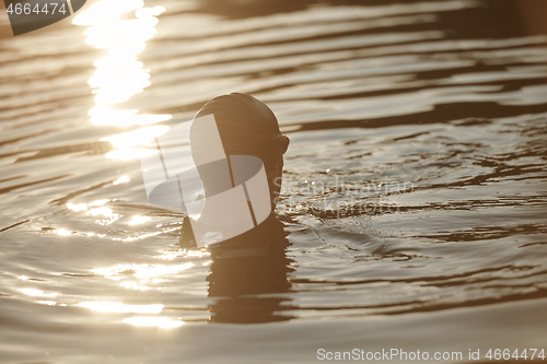 Image of triathlete swimmer having a break during hard training