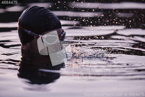 Image of triathlete swimmer having a break during hard training