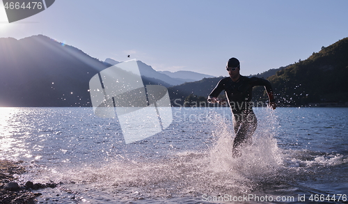 Image of triathlon athlete starting swimming training on lake