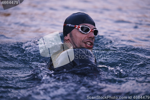 Image of triathlete swimmer having a break during hard training