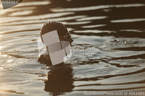 Image of triathlete swimmer having a break during hard training