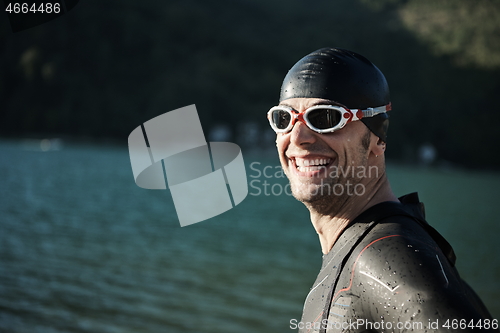 Image of triathlon athlete starting swimming training on lake