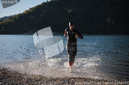 Image of triathlon athlete starting swimming training on lake