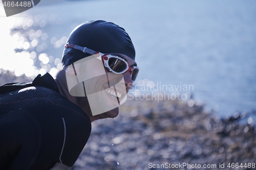 Image of triathlon athlete starting swimming training on lake