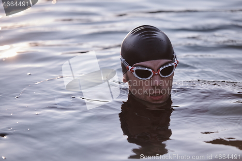 Image of triathlete swimmer having a break during hard training