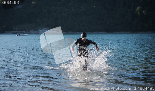 Image of triathlon athlete starting swimming training on lake