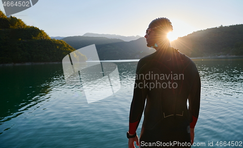 Image of triathlon athlete starting swimming training on lake