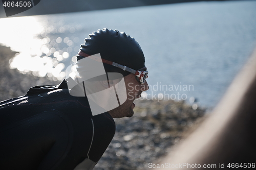 Image of triathlon athlete starting swimming training on lake