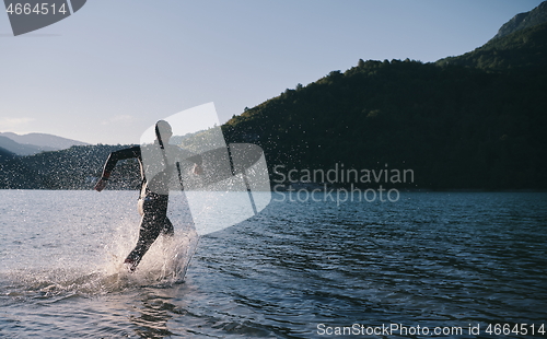 Image of triathlon athlete starting swimming training on lake