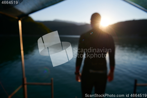 Image of triathlon athlete starting swimming training on lake