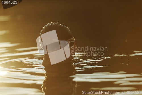 Image of triathlete swimmer having a break during hard training