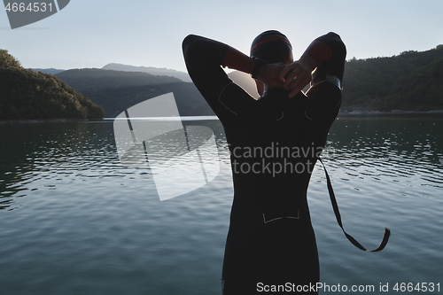 Image of triathlon athlete starting swimming training on lake