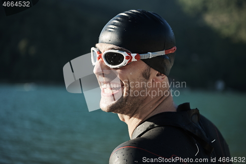 Image of triathlon athlete starting swimming training on lake