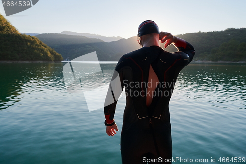 Image of triathlon athlete starting swimming training on lake