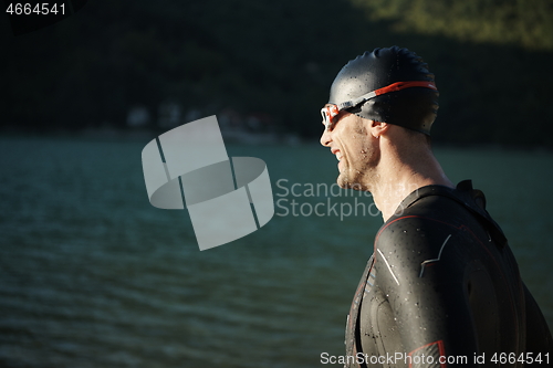 Image of triathlon athlete starting swimming training on lake