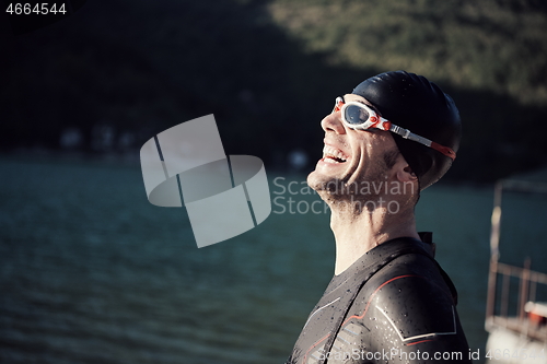 Image of triathlon athlete starting swimming training on lake