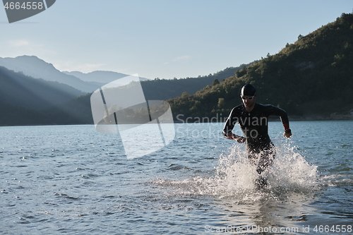 Image of triathlon athlete starting swimming training on lake