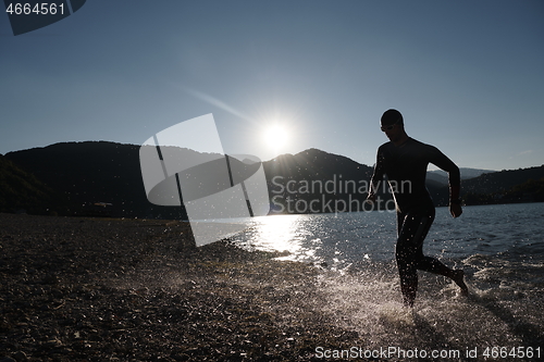 Image of triathlon athlete starting swimming training on lake