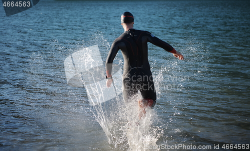 Image of triathlon athlete starting swimming training on lake