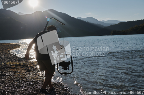 Image of videographer taking action shot of triathlon swimming athlete