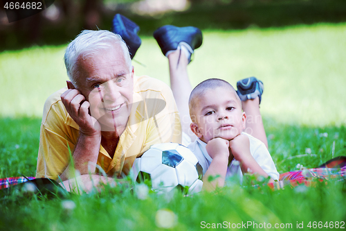 Image of grandfather and child have fun  in park