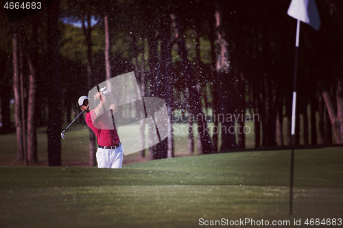 Image of golfer hitting a sand bunker shot