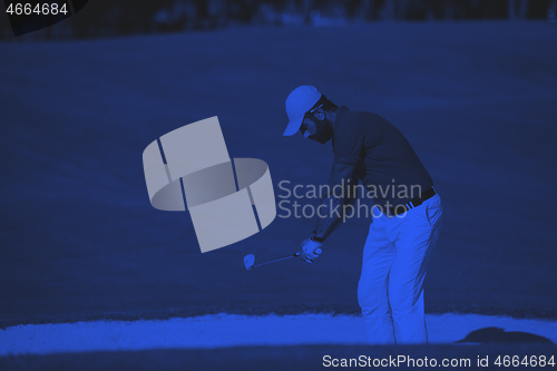 Image of golfer hitting a sand bunker shot