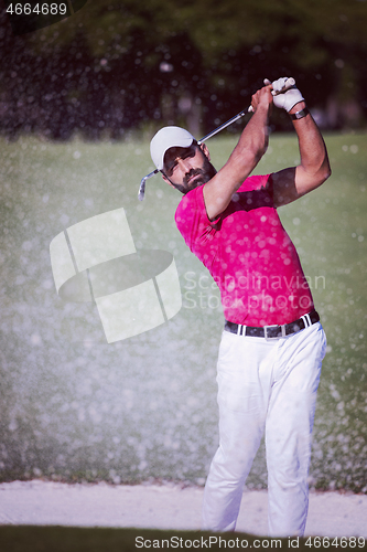 Image of golfer hitting a sand bunker shot