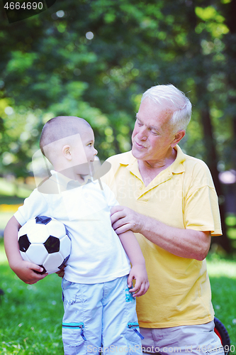 Image of happy grandfather and child in park