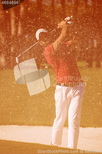 Image of golfer hitting a sand bunker shot