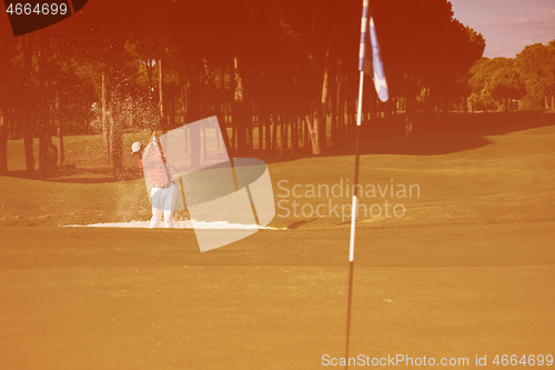 Image of golfer hitting a sand bunker shot